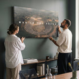 Two people hanging the Man In The Arena ancient Greek stadium canvas