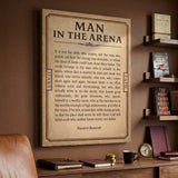 Man In The Arena Roosevelt quote ticket canvas above a credenza with books