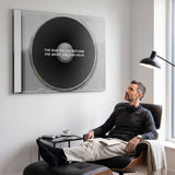 Man working at a music desk below the More You Can Hear black CD canvas