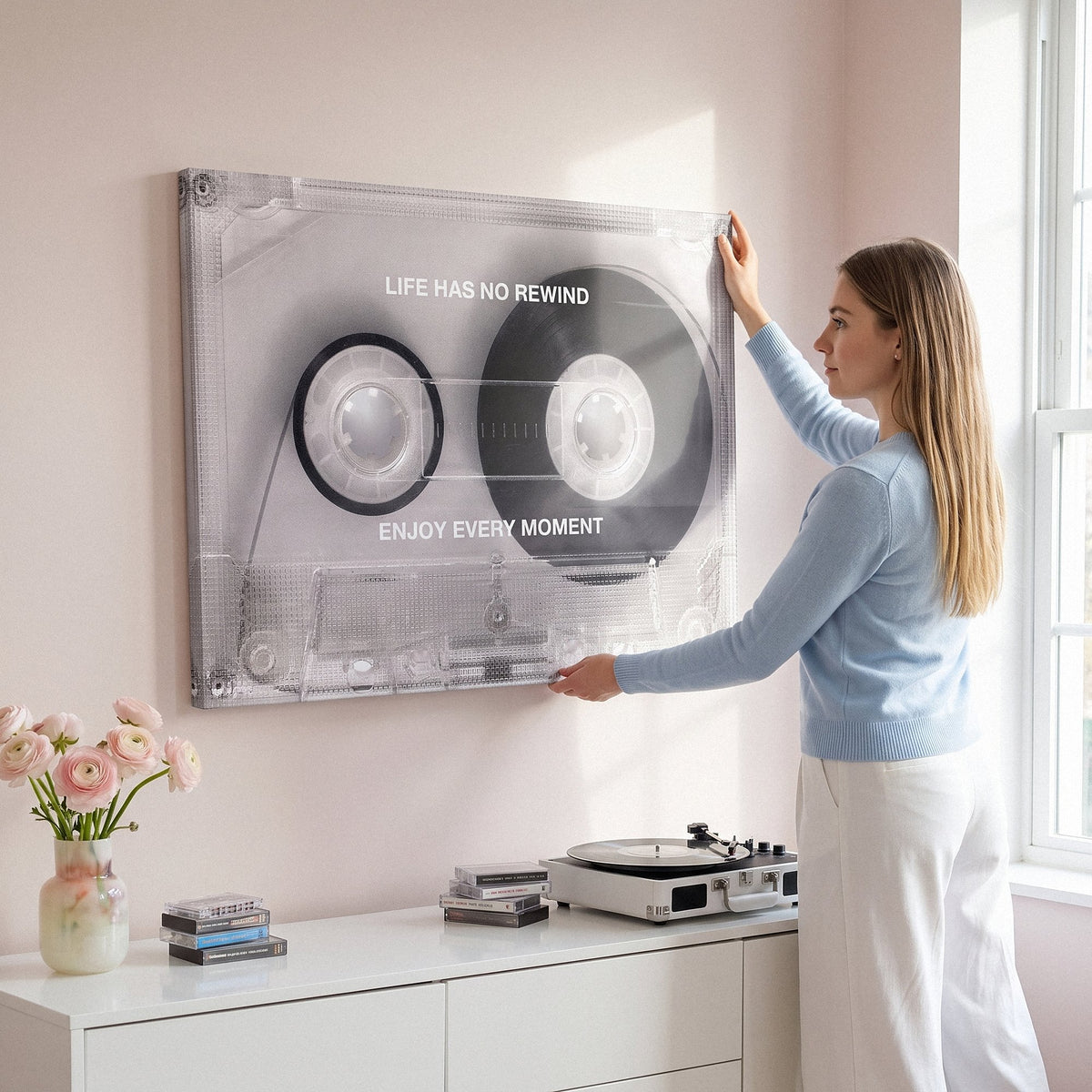 Woman working at a desk below the No Rewind Flip Edition flipped cassette canvas