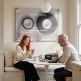 Couple relaxing in a lounge under the No Rewind Flip Edition flipped cassette canvas