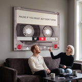 Couple relaxing in a lounge under the Pause If You Must clear cassette canvas