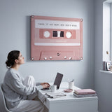 Pause If You Must canvas above a desk with a person looking at it