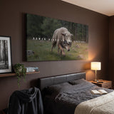 Power Hides In The Shadows canvas above a leather headboard, angled view showing the gallery wrap edge