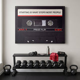 Press Play black cassette canvas hanging on the wall of a modern home office