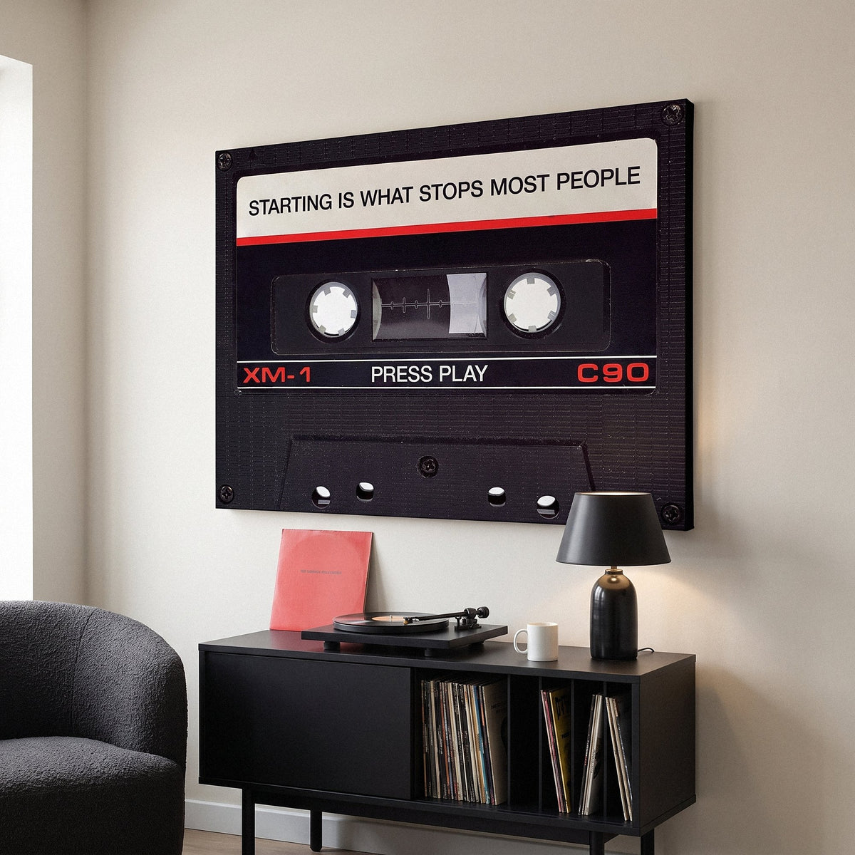 Press Play black cassette canvas on the wall of a contemporary living room
