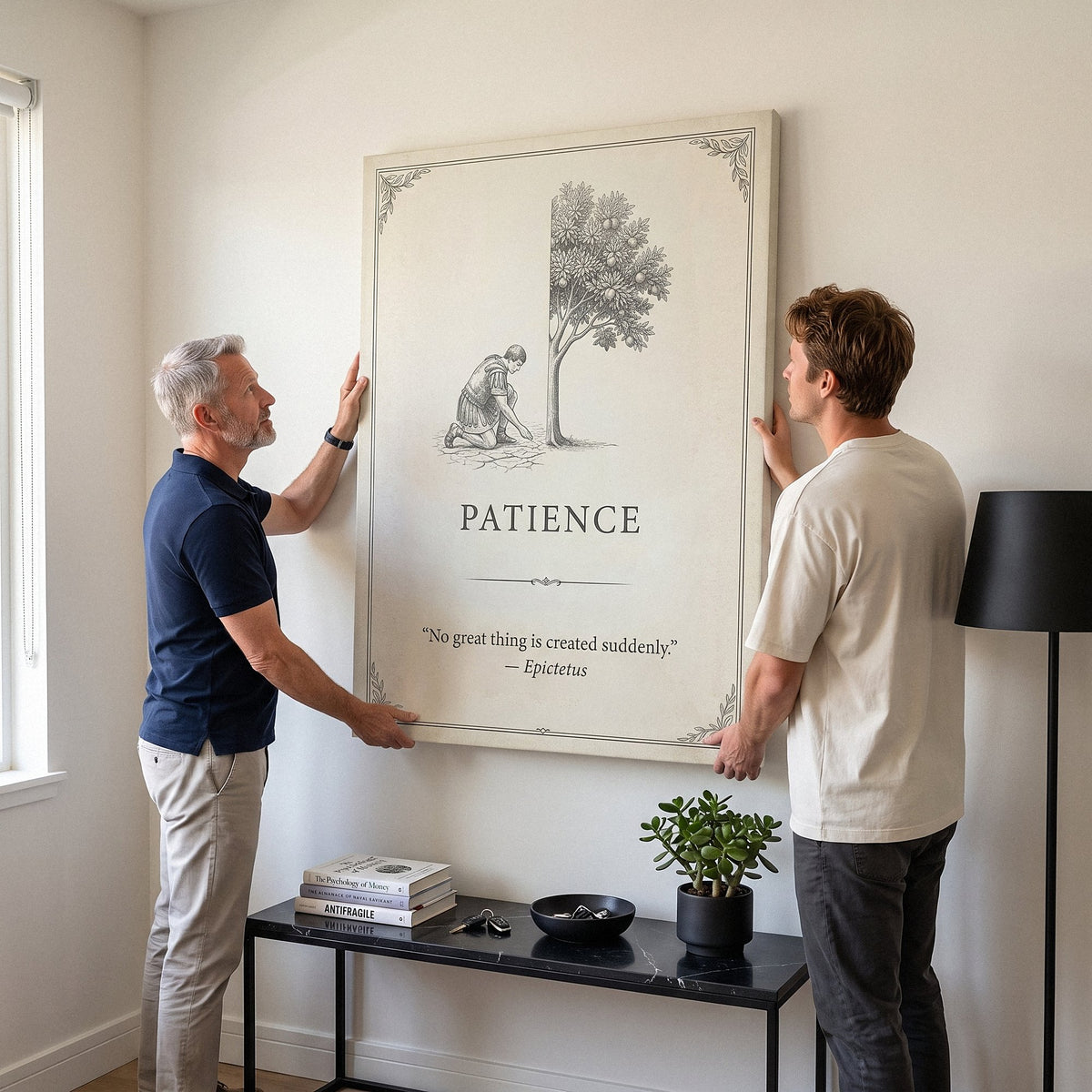 Father and son hanging the Seed Of Patience quote canvas in a living room