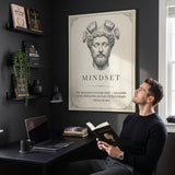 Man reading Meditations at his desk below the Stoic Mindset Marcus Aurelius canvas