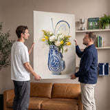 Two men holding the Tennis Vase canvas up against the wall above a leather sofa