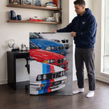 Man holding The Four coupe generation lineage canvas wall art in a styled study