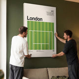 Two people holding the The London Slam tennis canvas print in a living room