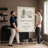 Two brothers carrying the Walk Your Path quote canvas in a living room