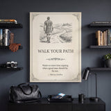 Walk Your Path quote canvas between black bookshelves above a console with a weekender bag