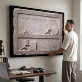 Man hanging the Work Smarter Not Harder marble canvas in a modern home office