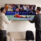 Two people viewing the Worth Everything tennis canvas print together in a home setting