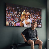 Person admiring the Worth Everything Trophy tennis canvas print in a styled interior