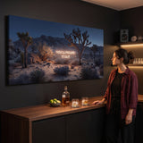 Woman at a home bar looking at the You'll Figure It Out canvas glowing on a dark wall
