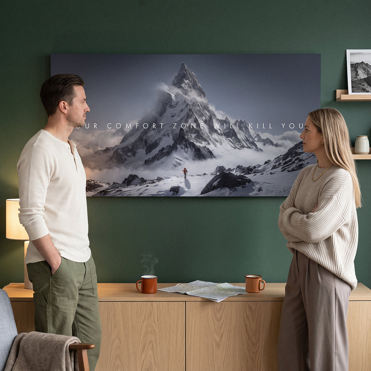 Your Comfort Zone Will Kill You wall art in a forest green dining area with two people looking at it