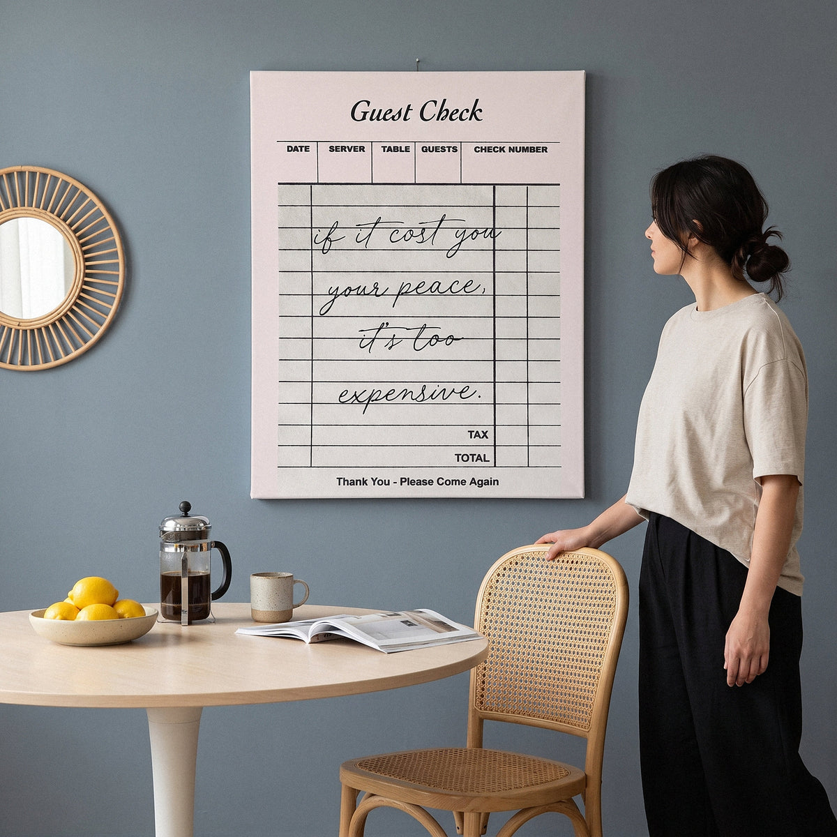 Woman looking at the Your Peace Check canvas in a slate blue breakfast nook